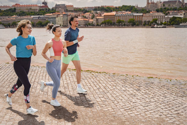 istock Three friends jogging along the Danube River in Budapest on a sunny day 2169240324