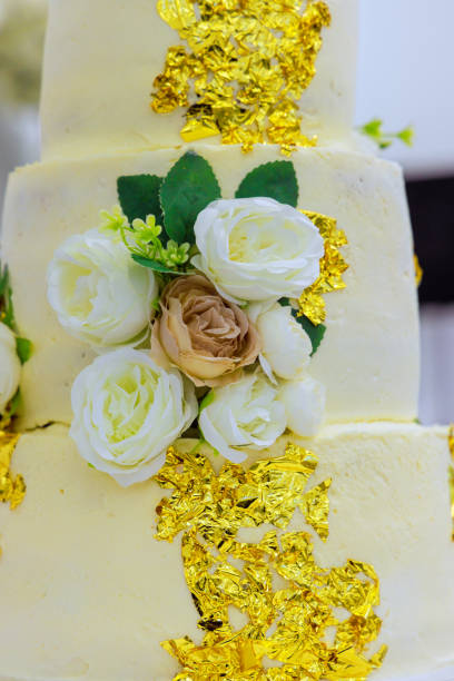 istock Peach wedding cake decorated with flowers beautiful roses on restaurant a table 2169241527