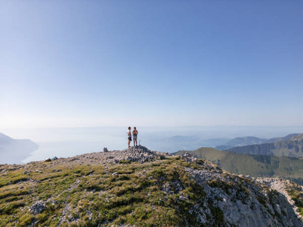 istock Couple Enjoying Panoramic View from Mountain Summit 2169241546