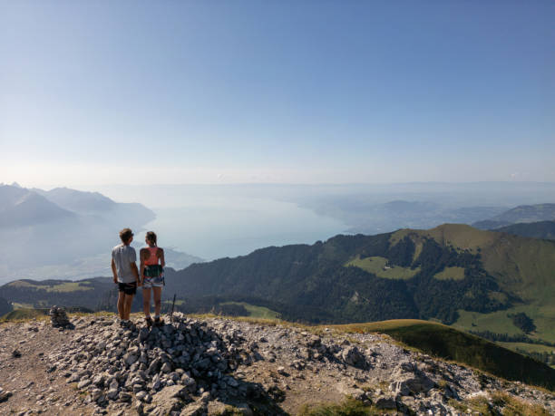 istock Couple Enjoying Panoramic View from Mountain Summit 2169241549