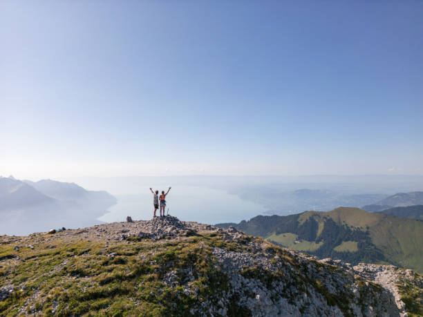 istock Couple Enjoying Panoramic View from Mountain Summit 2169241552