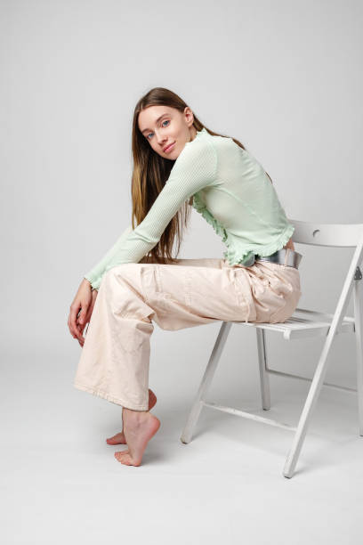 istock Young Woman Model Sitting and Posing in Studio 2169243643
