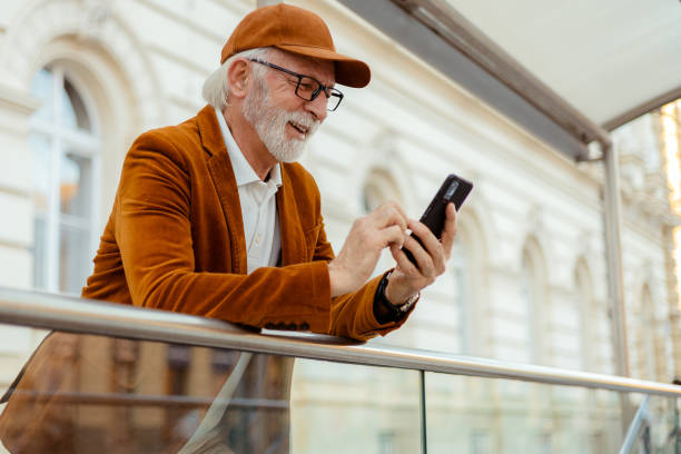 istock Urban Senior Hipster Man Using Smartphone Outdoors 2169246036