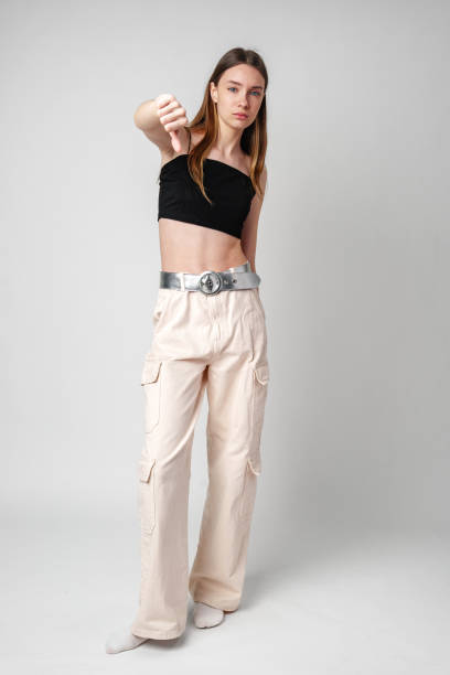 istock Young Woman Giving Thumbs Down in Studio 2169246257