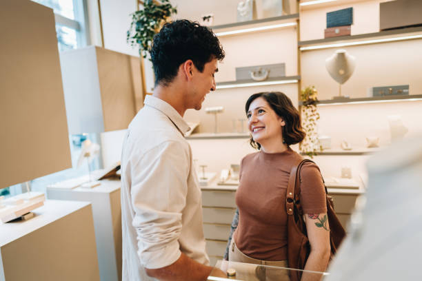 istock Young couple talking on a jewelry store 2169250236