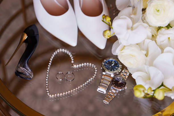 Table with accessories for the bride and groom. wedding rings, shoes, watches and bouquet.
