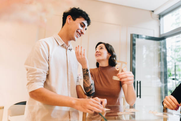 istock Young couple talking on jewelry store 2169255229