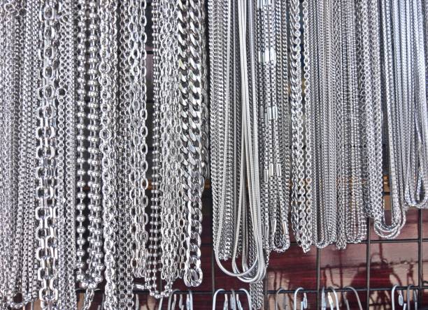 Zipper concept as an open interlocking metal fastener on clothing or garment textile as a symbol for revealing a message or discovery isolated on a white blank background.