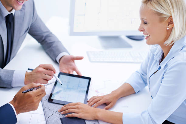 istock Tablet, woman or hands of engineers in meeting for planning or engineering group project. Architecture strategy, teamwork or people with technology on digital screen, development or blueprint design 2169258216