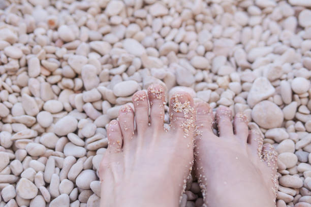 View of feet on a rocky beach