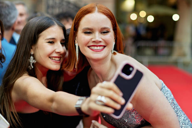 istock Fan and celebrity taking selfie at red carpet event 2169266815