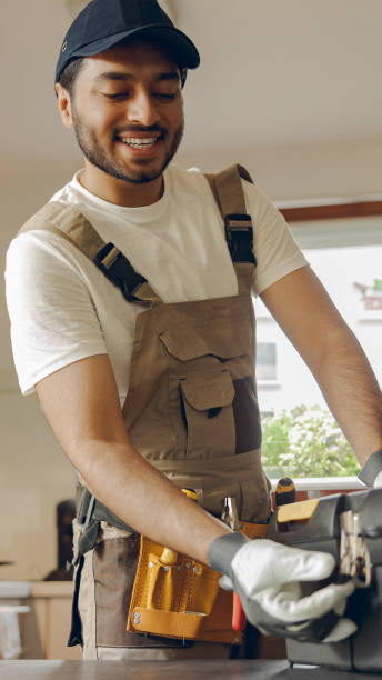 istock Smiling professional handyman standing on home kitchen and open his tool bag 2169266992