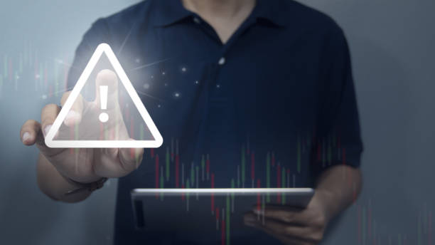 istock Risk warning in financial and investment trends down ,Businessman using tablet working with triangle indicator analysis trading stock price chart ,World economic crisis concept 2169267604