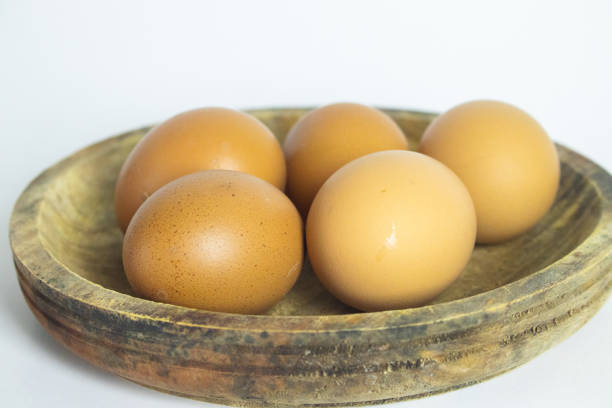 Fresh Brown Eggs Neatly Packed in Pink Plastic Carton - Isolated on White Background