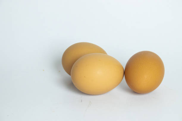 Three newly laid brown eggs, representing natural and healthy food.