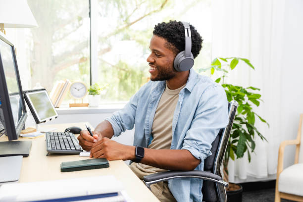 istock Student looks up from notes to smile at virtual classmate 2169270938