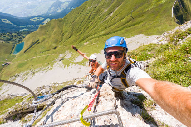 istock Couple Taking Selfie While Climbing Steep Via Ferrata 2169271021