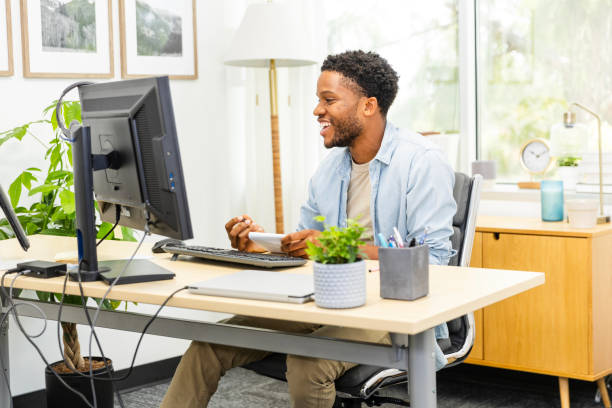 istock Cheerful young man enjoys his online college class 2169271045