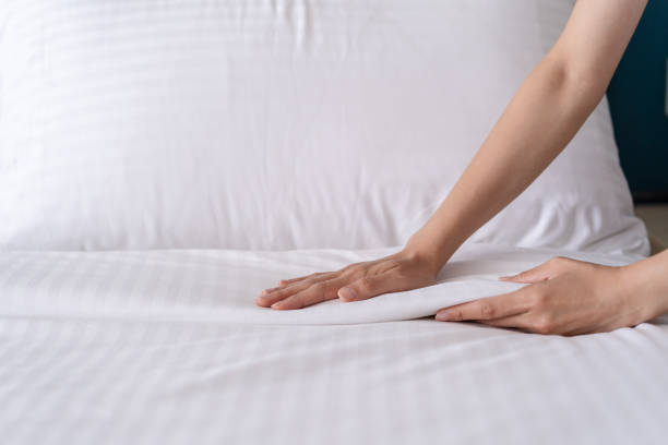 istock Close-up of hands setup bed sheet. House keeping. 2169272474