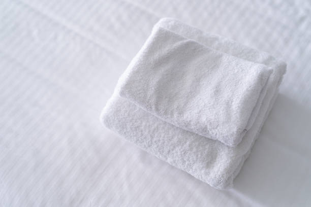 istock A stack of new and clean bath towels on a bed. House keeping. 2169272475