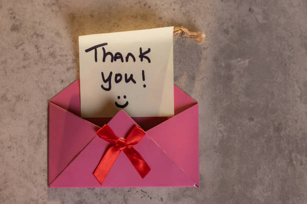istock A pink envelope with a red ribbon and a note that says 