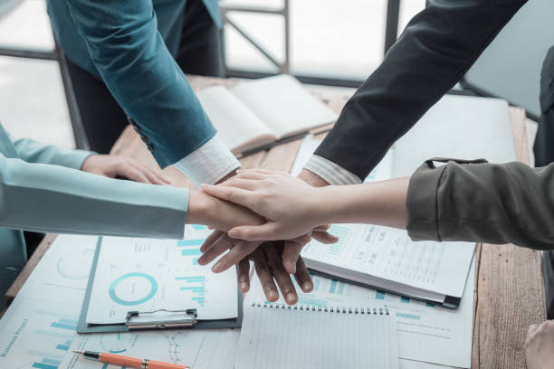istock Businessmen shaking hands, greeting and working together, having documents with financial graphs and charts, brainstorming, close-up photo 2169274606