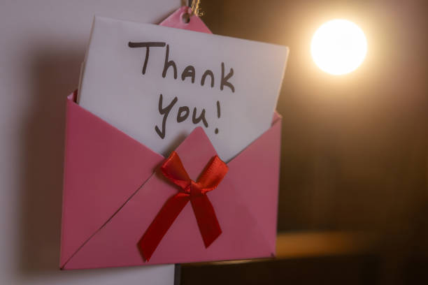 istock A pink envelope with a red ribbon and a note that says 