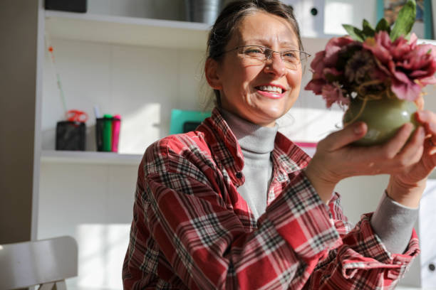Senior Lady Embracing the Joy of Plants While Working from Home