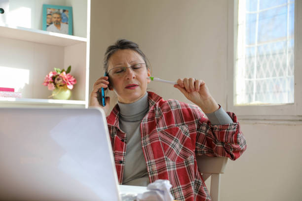 istock Smiling Elderly Woman Relaxing During a Phone Call at Home 2169280514