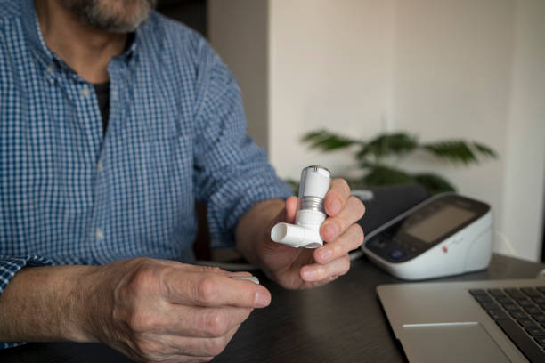 istock Senior Man With Chronic Bronchitis is Using Inhaler 2169281931