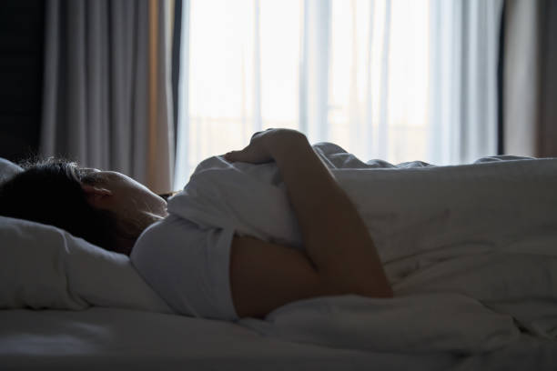 istock Woman Sleeping in Bed with Morning Light 2169284002