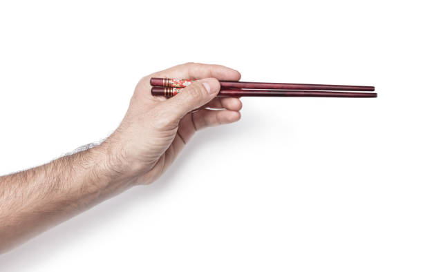 istock man's hand with chinese sticks isolated white background. 2169288303