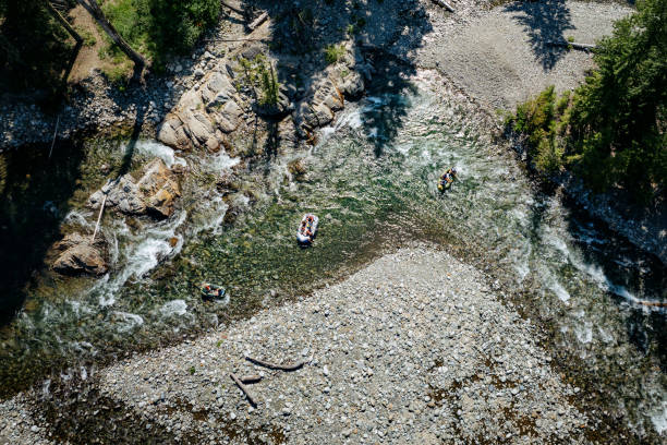Pacific Northwest beauty on display as a group of people raft down a river in Washington state, USA.  Shot in Salmon La Sac area in Western Washington near Snoqualmie Pass.
