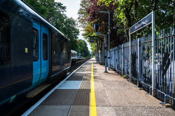 Passenger trains by a platform in summer