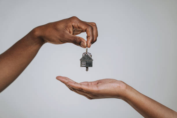 istock Hand handing over keys to new house 2169294766