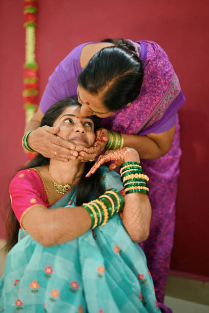 istock Grandmother kissing bride's forehead during Pre-Wedding Rituals 2169296898