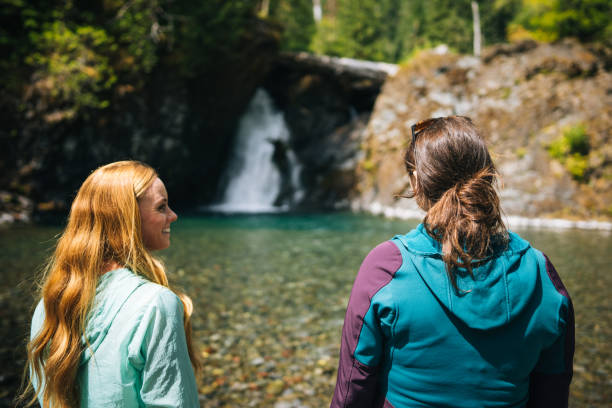 istock Young women explore waterfall and pond 2169297551