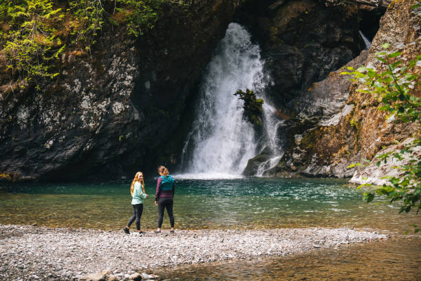 istock Young women with dog explore waterfall 2169297771