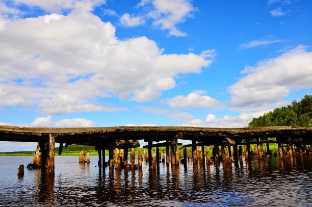istock A sunny day, a bridge over the river and a pile from an old ruined bridge 2169298634