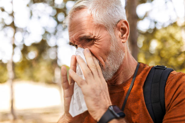 istock Senior Man Wipes Sweat While Hiking in Autumn Woods 2169299370