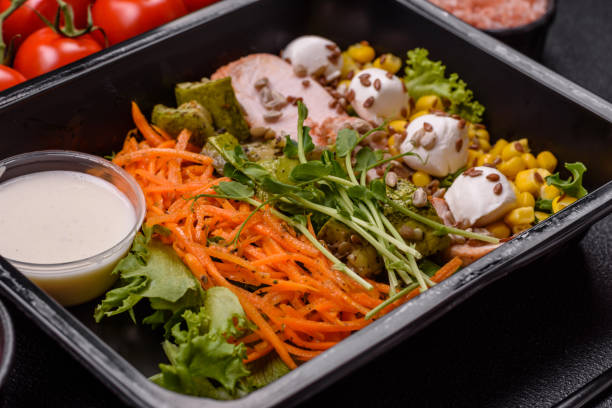 istock Fresh juicy salad with meat, mozzarella, carrots, lettuce, corn 2169301404