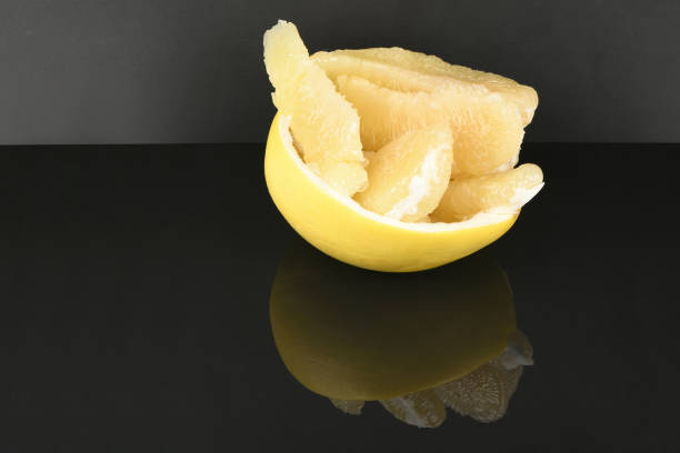 Pomelo isolated on acrylic black background. High resolution photo. Full depth of field.