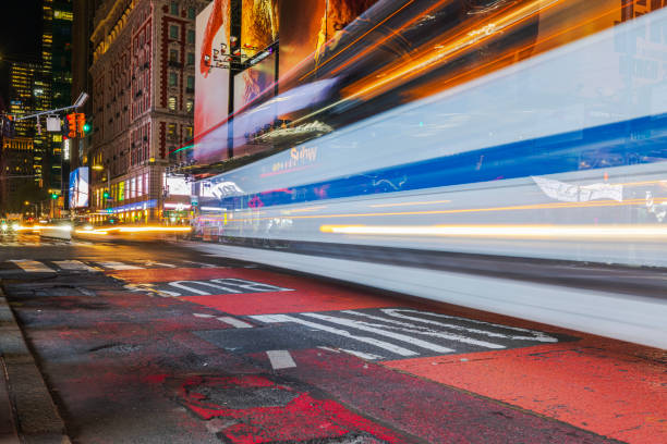 USA. New York. 08.30.2024. Night view of Manhattan with light tracers from passing car headlights, creating blurred light trails and streaking effects.