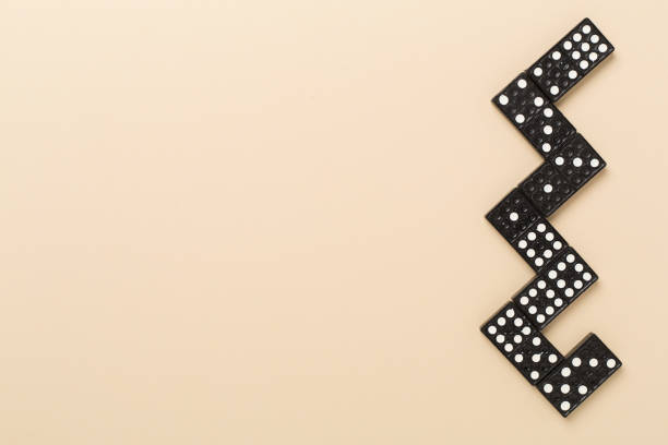Black domino tiles on color background, top view