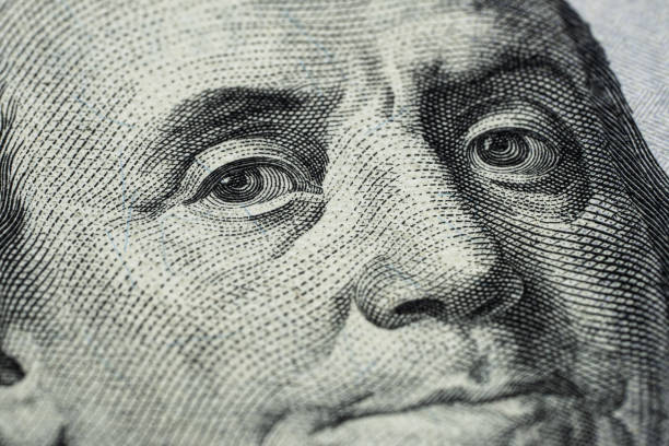 istock Close up shot of Benjamin Franklin's face on a hundred dollar banknote. 2169325477