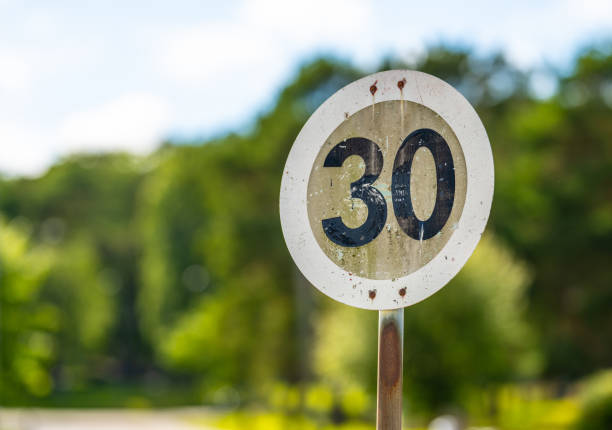 Old speed sign where the sun has bleached away all the red paint