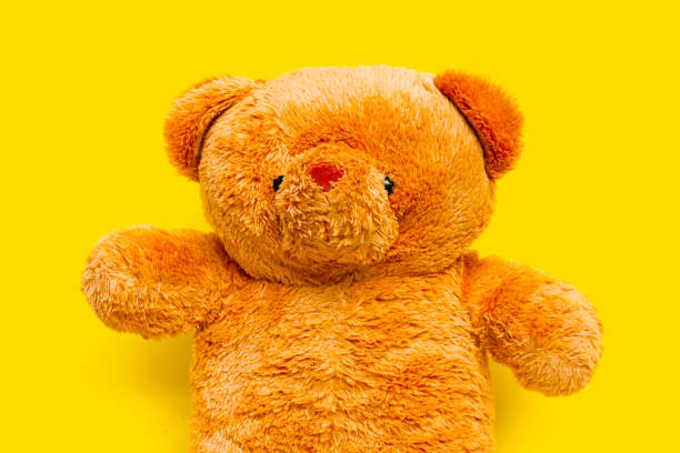 Bear toy on yellow background