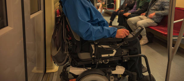 istock Man on electric wheelchair on train 2169345269
