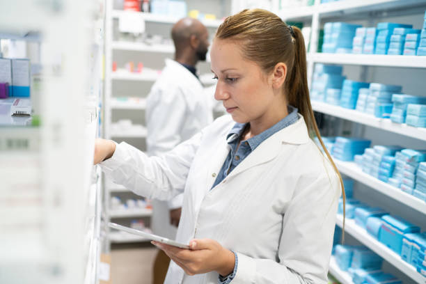 istock Pharmacist searching for medicine in storage room 2169349136