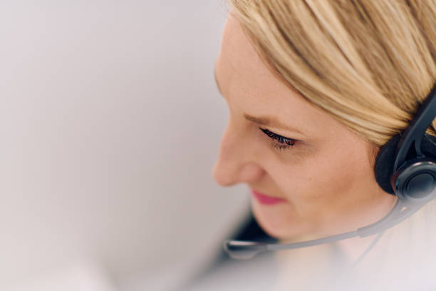 istock Friendly Call Center Agent Answering Incoming Calls with Headset Providing Remote Customer Service. 2169349299